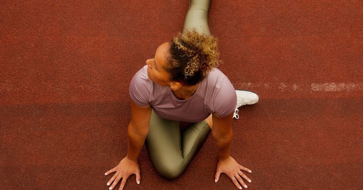 Athlete warming up with gentle stretches in golden light