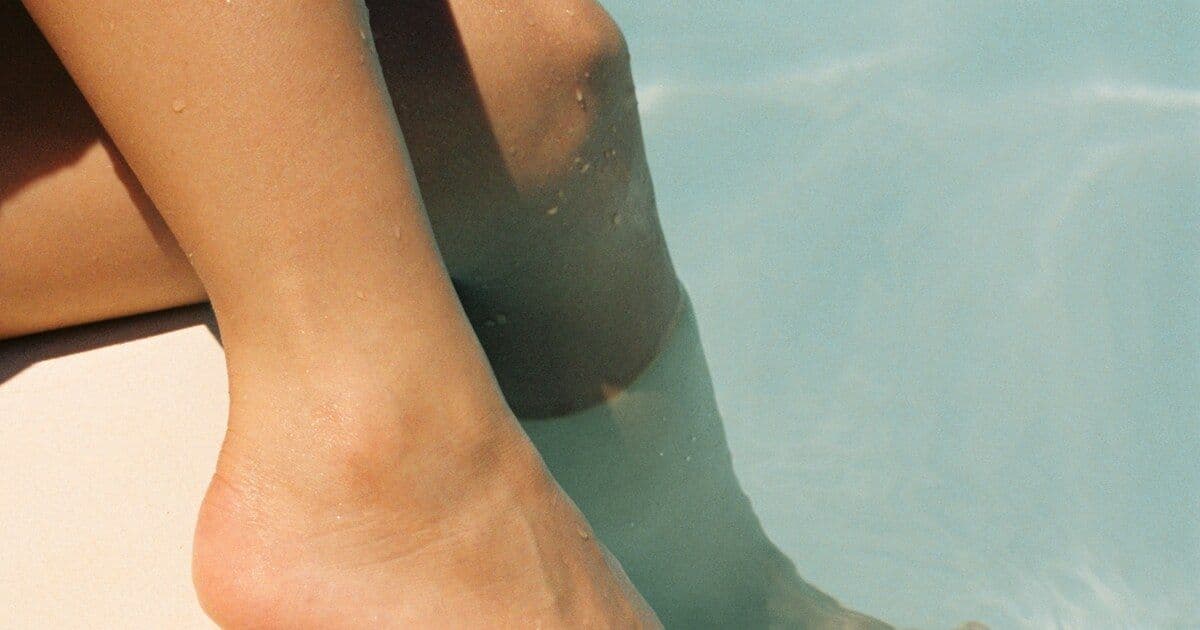 human legs, ocean water, beach activity